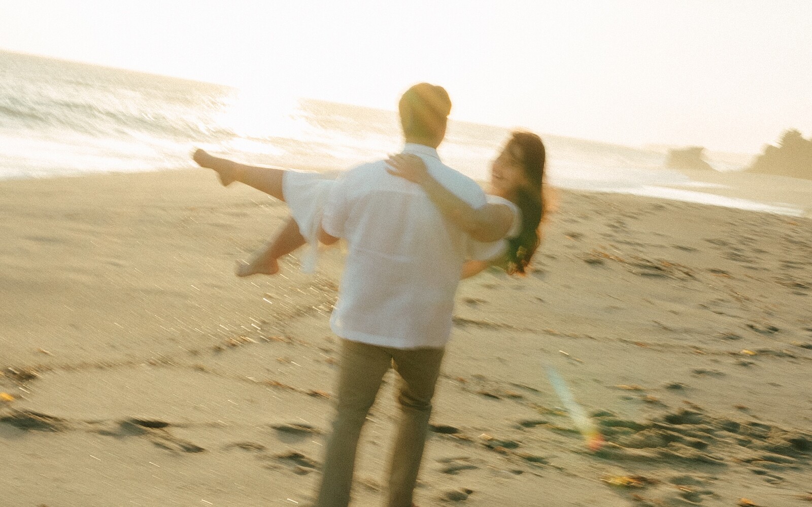 Larissa and Tony dancing on the beach at sunset