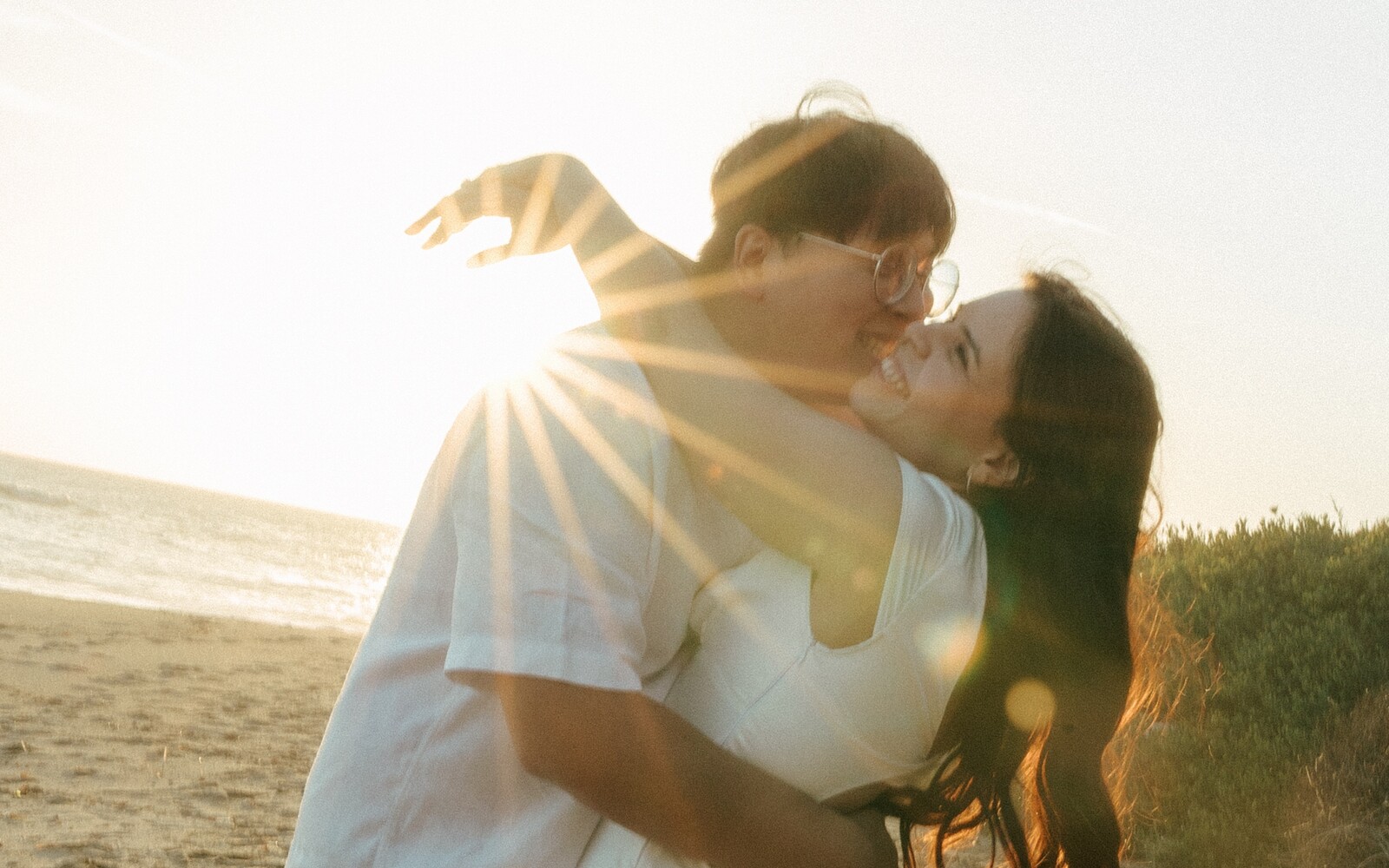 Larissa and Tony kissing in the sun