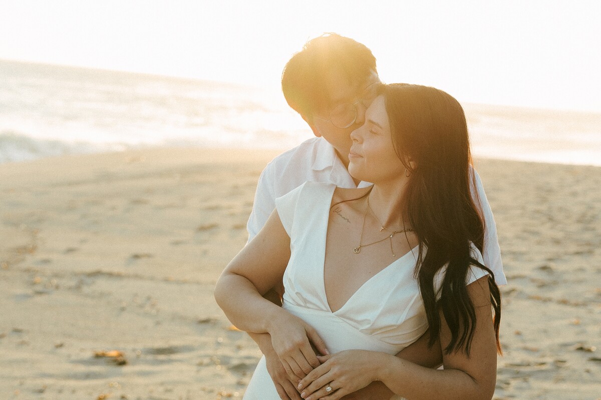 Tony holding Larissa from behind at golden hour