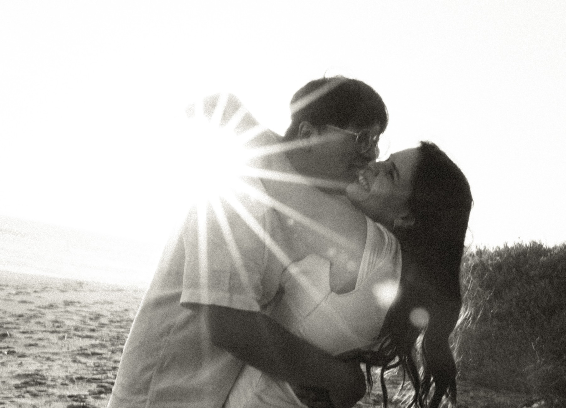 Larissa and Tony at golden hour, backlit kiss
